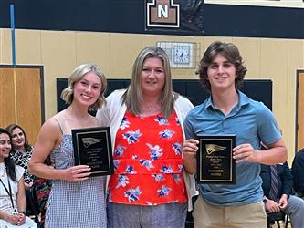 students and teacher posing with awards