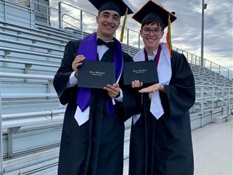 two students in graduation cap and gowns