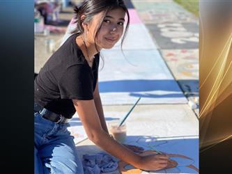 Senior Student painting a sidewalk