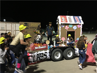 students walking in front of a parade float