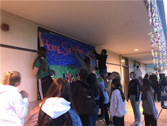 students decorating a window