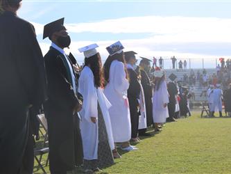 a line of students in cap and gowns